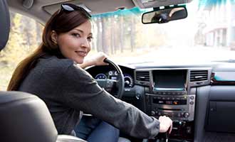 young driver behind the wheel of a car with a collision mitigation system