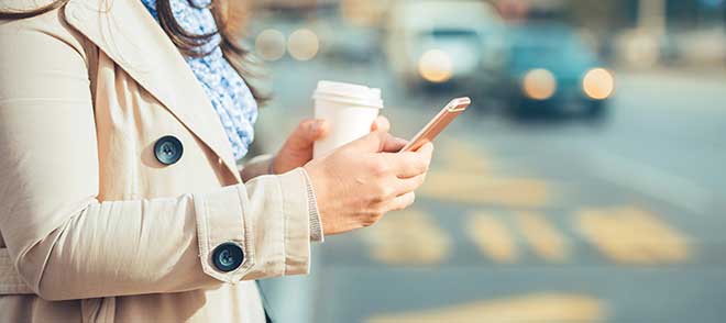 Woman whom is distracted walking with her smartphone