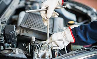 auto body repairman inspecting auto property damage claim