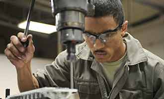 worker using drill press