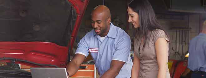 A mechanic assisting a customer with their car problems.