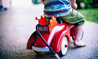 child riding a safe toy