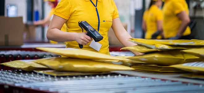 large fulfillment facility employee scanning packages