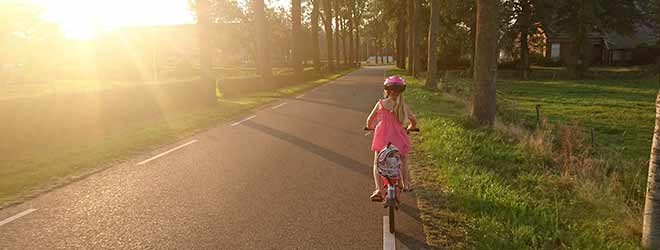 young girl practicing bicycle safety