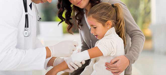 Doctor applying a bandage to child after dog bite