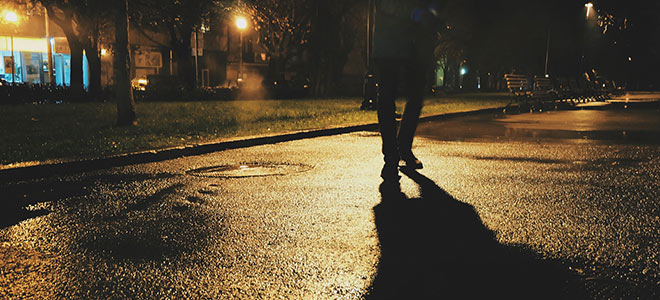 Pedestrian crossing the road in the dark