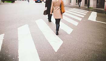pedestrian walking across crosswalk