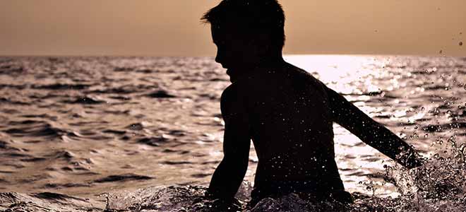 boy swimming at the beach