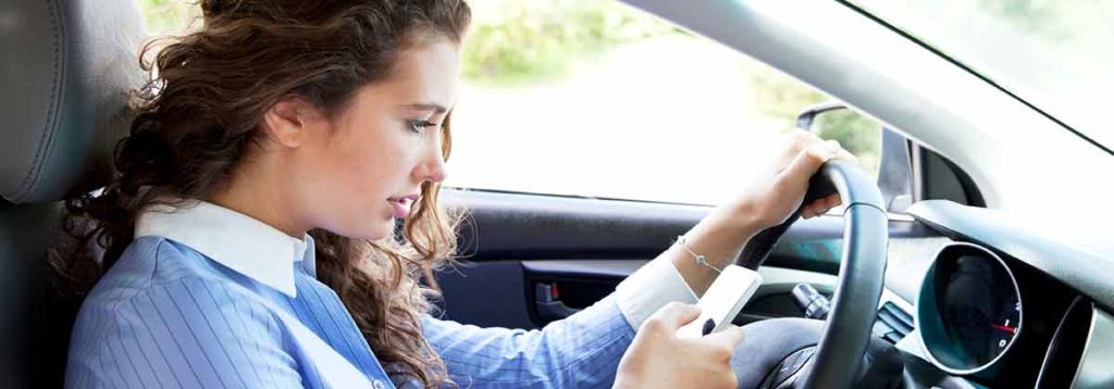 Woman looking at her phone while driving will fail a textalyzer test