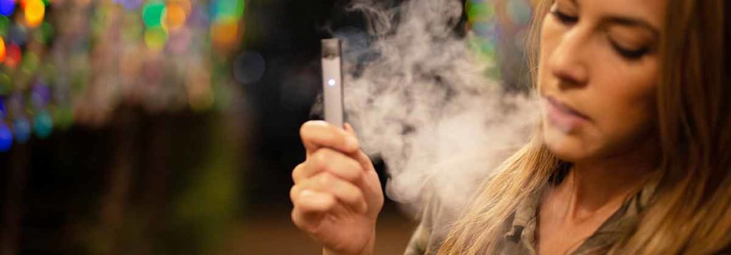 Young woman using a Juul e-cigarette