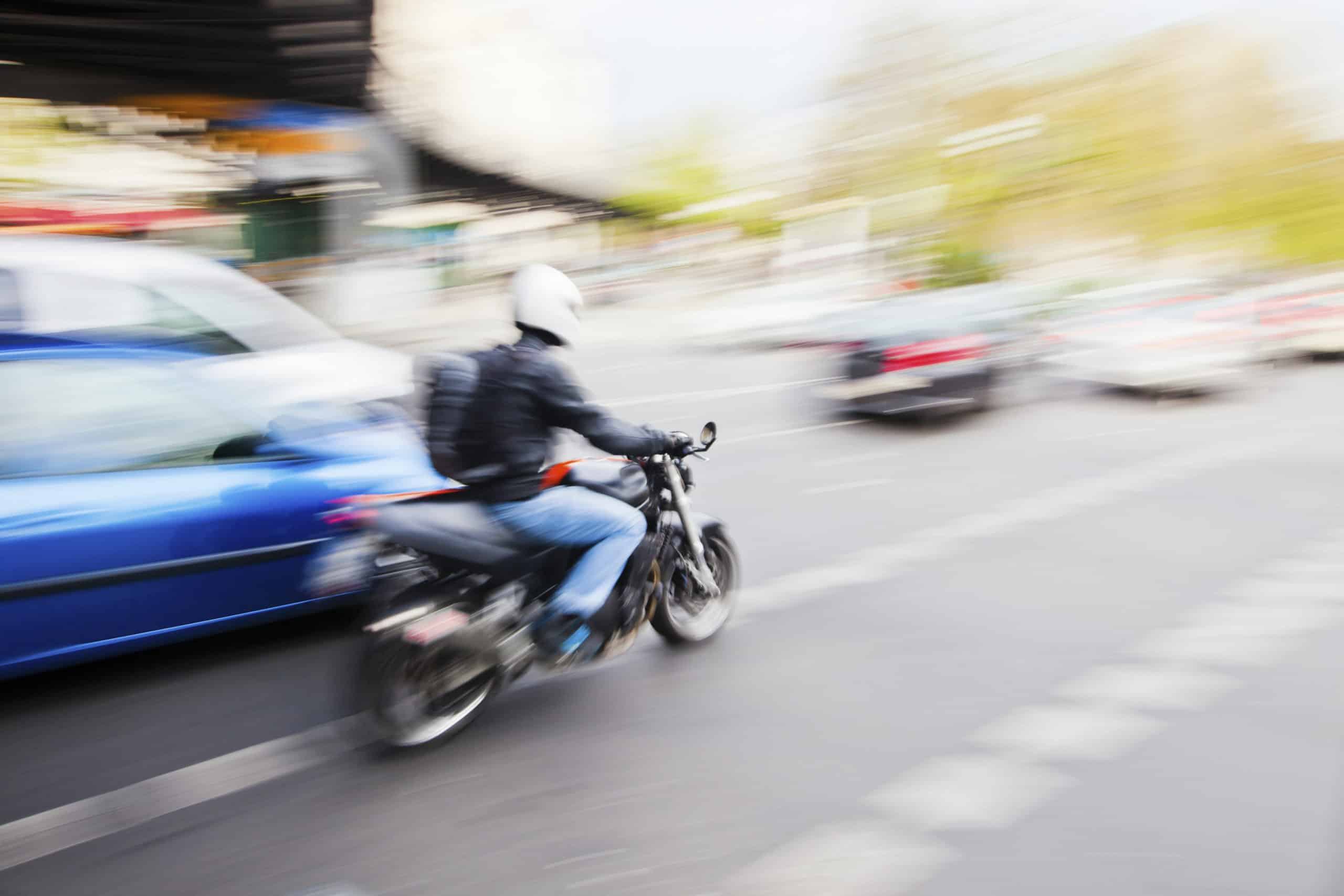 Motorcycle rider passing vehicle