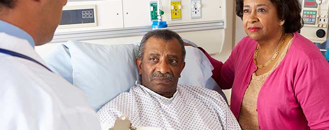 Man in hospital bed receiving news on prostate cancer. 