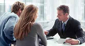A lawyer talking to two clients about a failure to diagnosis breast cancer case. 