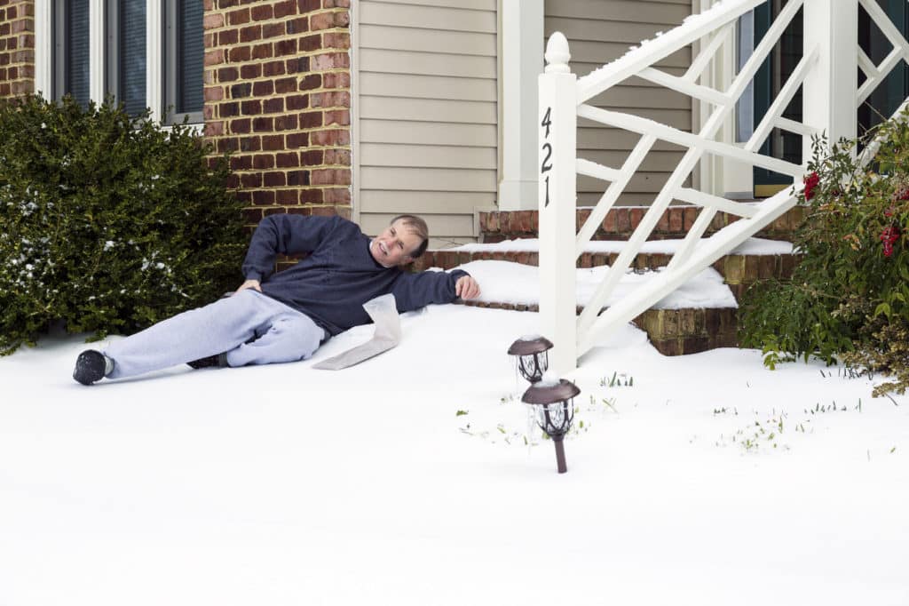 A man having a slip and fall accident on icy stairs. 