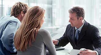 2 clients talking to a personal injury lawyer regarding a hip replacement lawsuit. 
