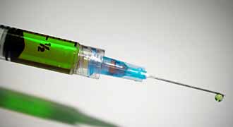 A needle with liquid dropping out. 