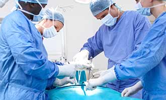 Surgeons preforming a hernia mesh implant surgery.