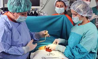 Surgeons performing a hernia mesh patch surgery. 