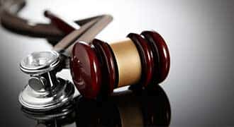 A judges gavel by a stethoscope. 