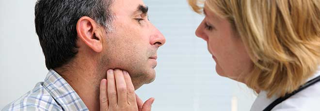 A doctor checking a patient's neck. 