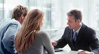 2 clients talking to a personal injury lawyer regarding a nursing home abuse case. 