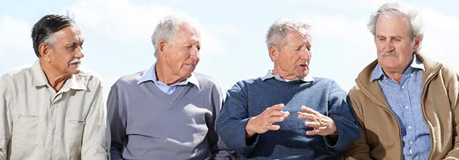 4 elderly men talking to each other. 