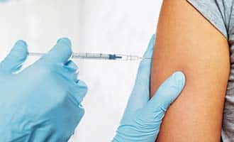A patients arm receiving a shot. 