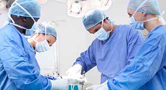 4 surgeons performing an operation. 
