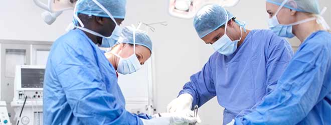 Four surgeons performing surgery.