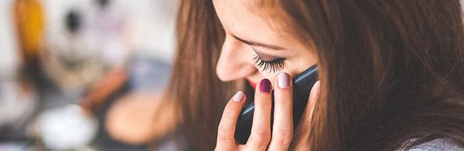Woman talking on the phone to a lawyer about her dog bite injury