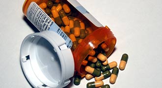 A bottle of pills split over. 