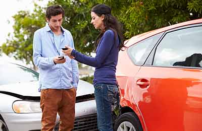 Car accident drivers exchanging insurance information