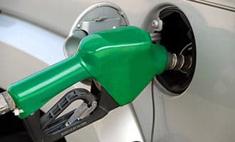 A gas nozzle sitting inside a gas tank.