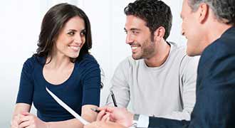 A personal injury attorney discusses a case with his two clients.