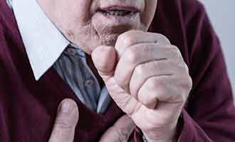 An elderly man coughing. 