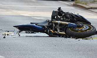 A motorcycle wrecked in the road.