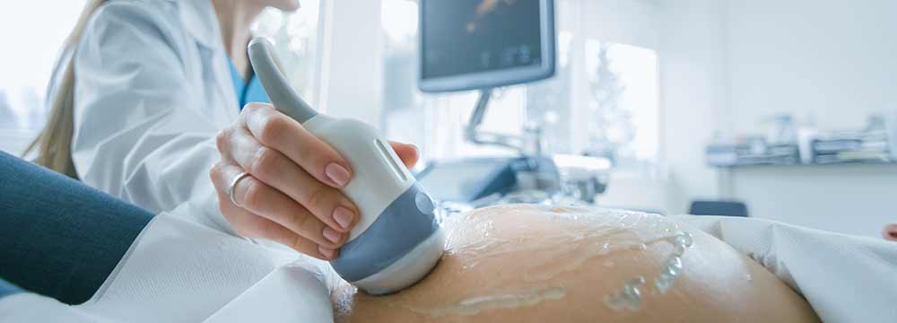A pregnant woman having an ultrasound.