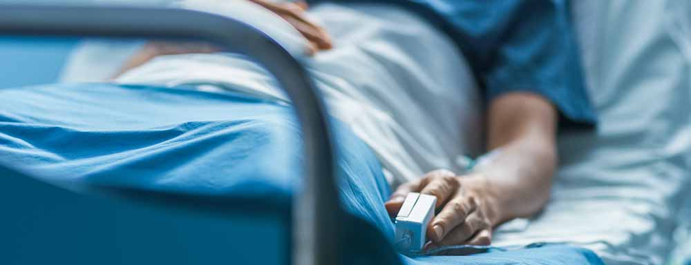 A patient lying in a hospital bed. 