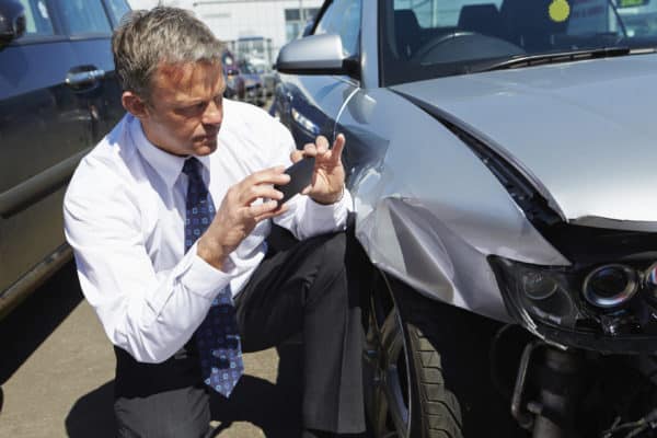 Man at scene of car crash taking photos
