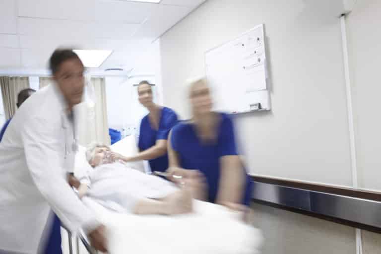 medical staff rushing patient to Emergency Room