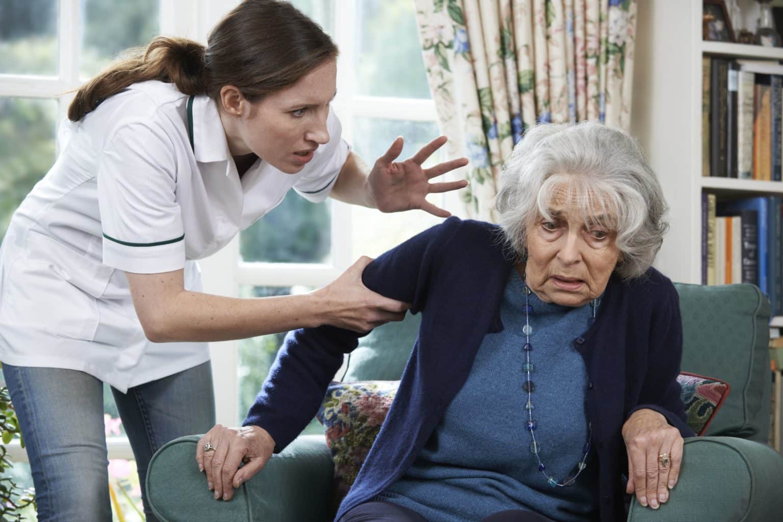 Nursing home staff member abusing elderly woman