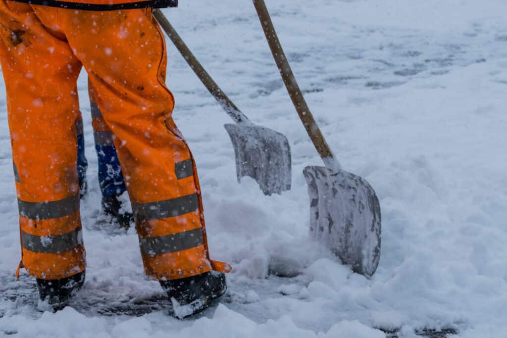 Workers snow shoveling