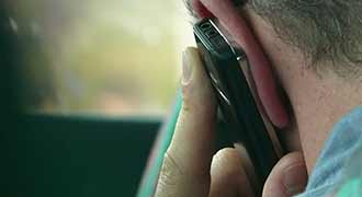 man calling his insurance company after an accident