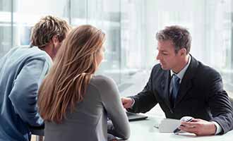 2 clients talking to a personal injury lawyer regarding a negligence case.
