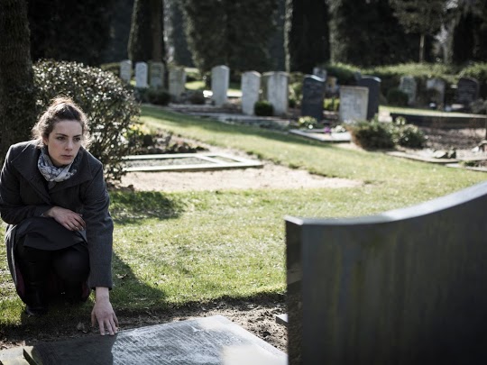Woman at grave of wrongful death victim