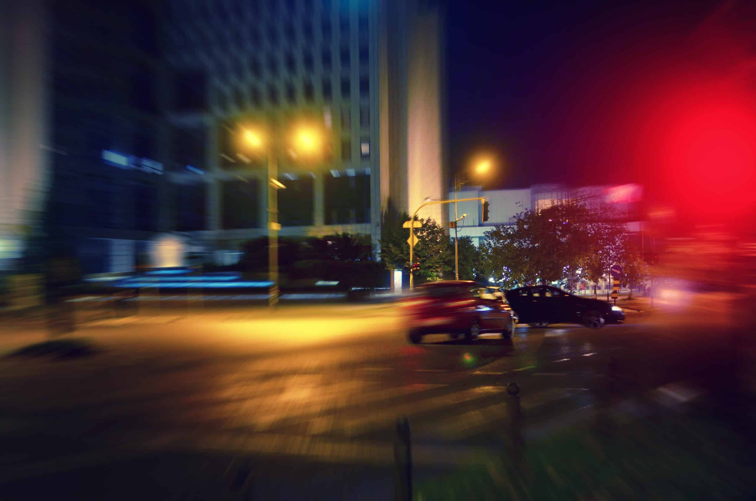 A car accident at night at a traffic light.