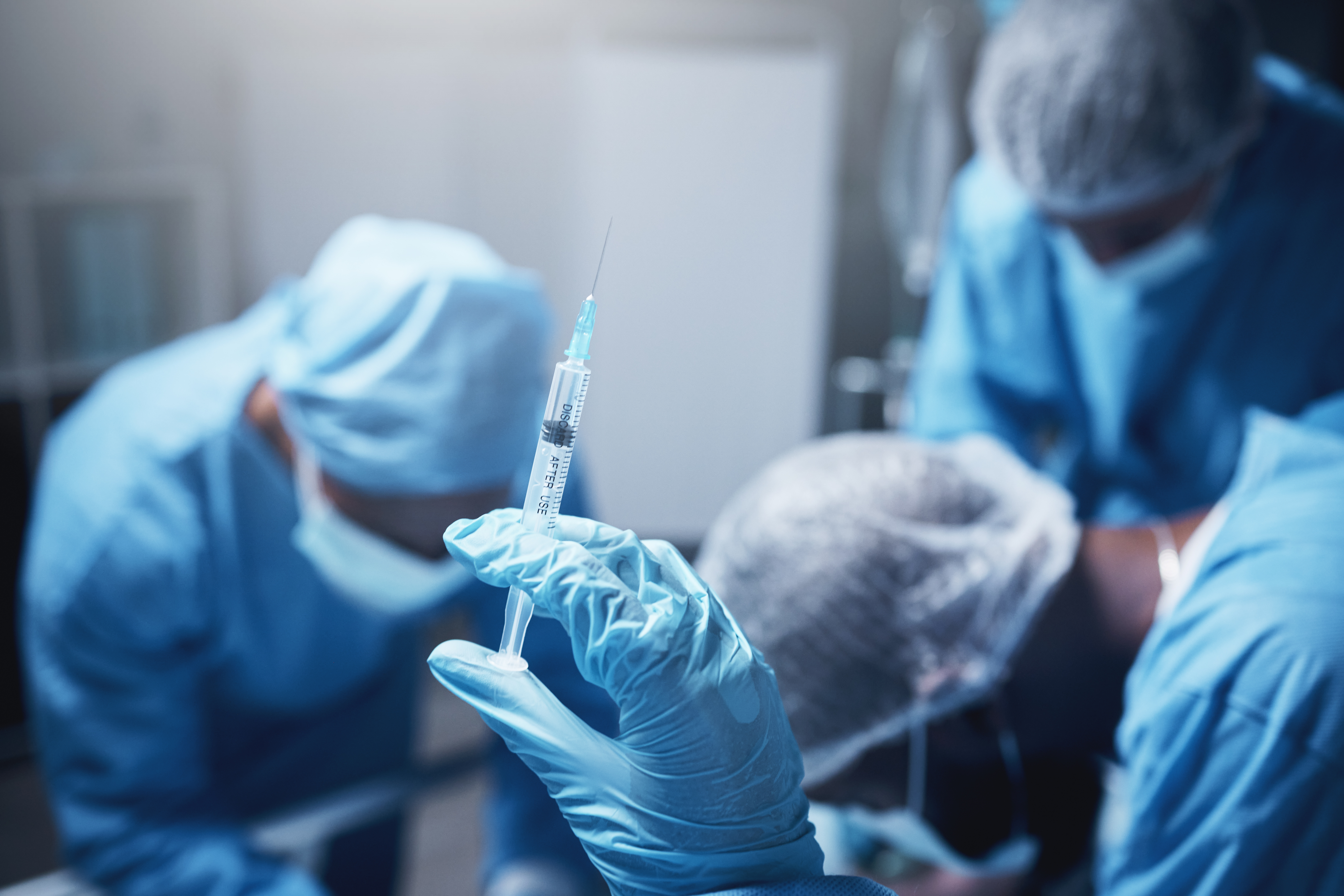 A doctor getting ready administer anesthesia.