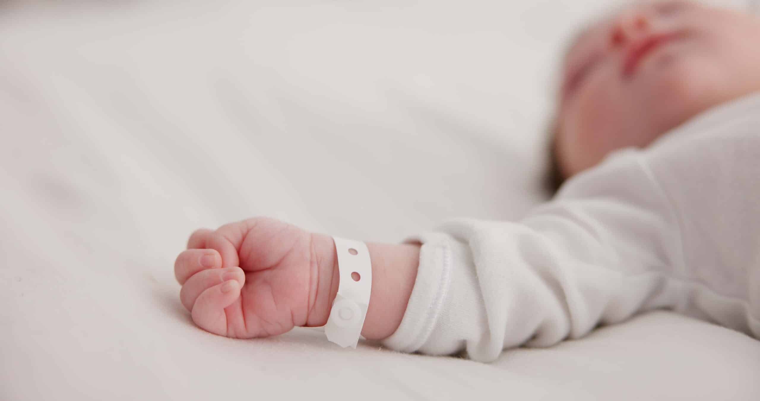 A baby with a hospital bracelet.