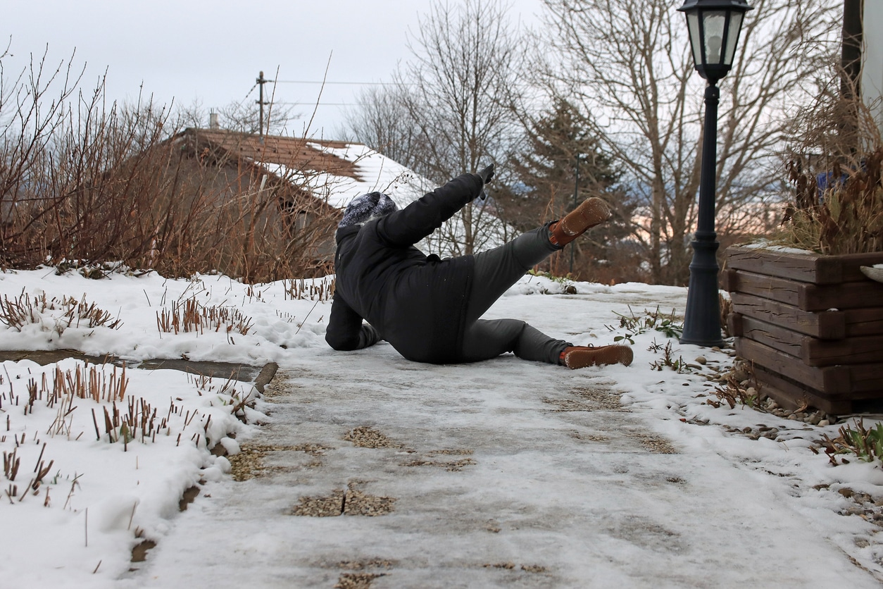 Man on the ground after he slipped and fell on ice.