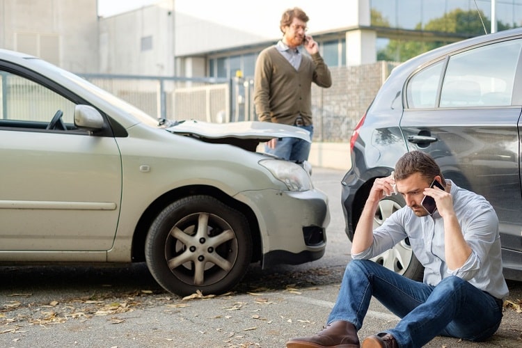 Car Accident victims calling their insurance companies after an accident